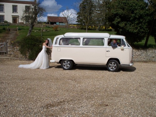 A VW T2 Classic Campervan called Bonnie and Here Bonnie is teasing the bridal party by pretending she needs a bump start by the bride. Cheeky! She always starts at the touch of the button. for hire in Exeter, Devon
