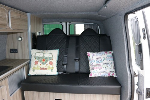 A VW T5 Campervan called Bertha and Bertha's bed up for hire in North Tawton, Devon