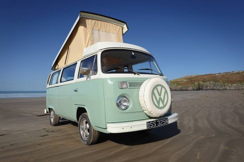 A VW T2 Classic Campervan called Enlli and Bessie with her pop-top roof up for hire in Garndolbenmaen, Gwynedd