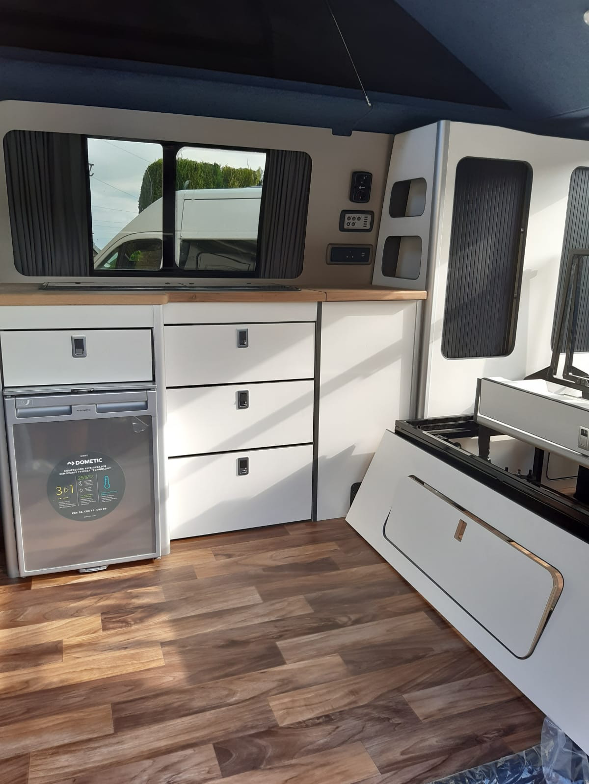 A VW T5 Campervan called Pacha and Wood flooring & Highspec cabinets for hire in Chelmsford, Essex