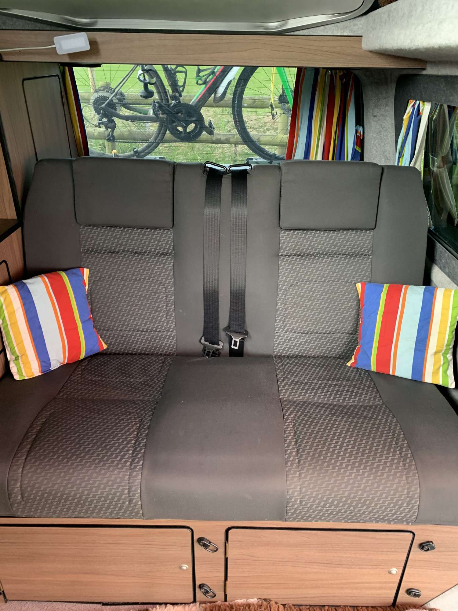 A VW T5 Campervan called Flo and Rib crash tested seatbed with storage under for hire 