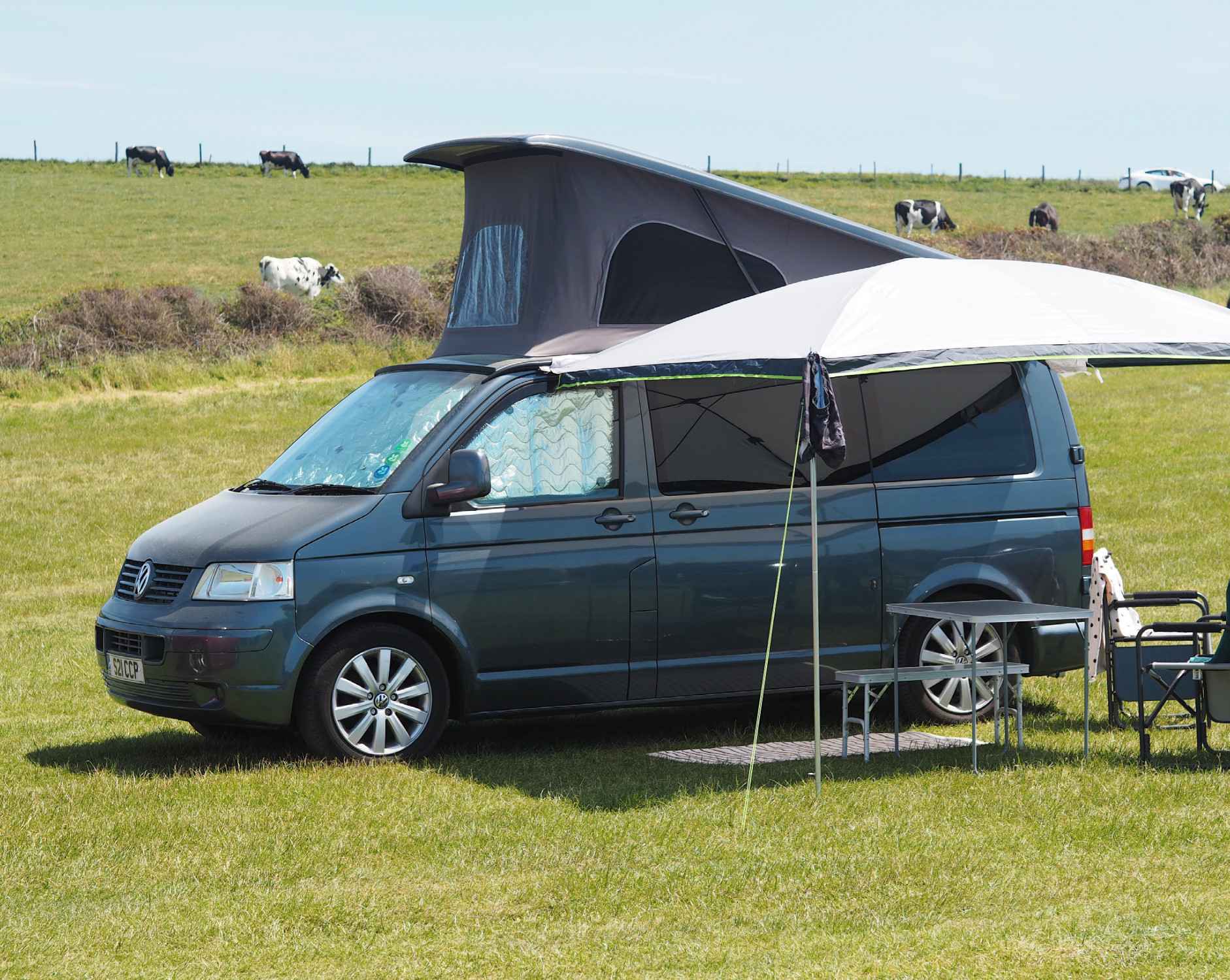 A VW T5 Campervan called rosie and Reimo Sun Canopy with picnic set up for hire in South Croydon, Surrey