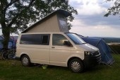 A VW T5 Campervan called Charlie and With Pop Top for hire in Dollar, 