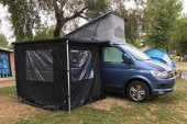 A VW T6 California Campervan called VeraT6-0720 and Side profile with awning for longer stays. Bags of space for hire in Hertford, Hertfordshire