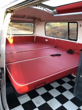 Bench seats folded to make full width bed