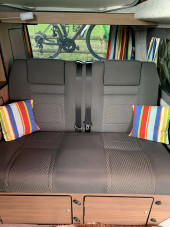 A VW T5 Campervan called Flo and Rib crash tested seatbed with storage under for hire 