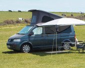 A VW T5 Campervan called rosie and Reimo Sun Canopy with picnic set up for hire in South Croydon, Surrey