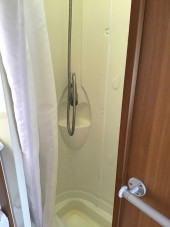 Shower with pull across shower curtain.